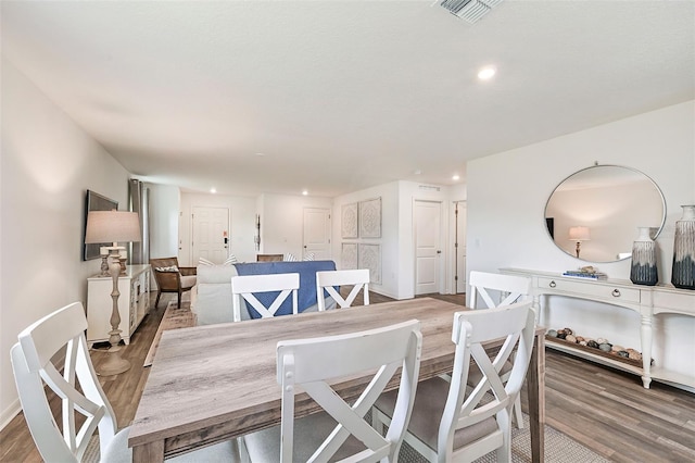 dining space with hardwood / wood-style floors