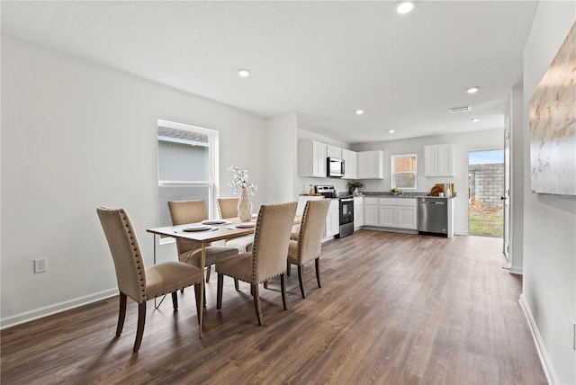 dining area with dark hardwood / wood-style flooring