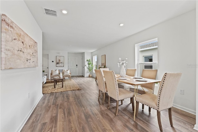 dining space with dark hardwood / wood-style floors