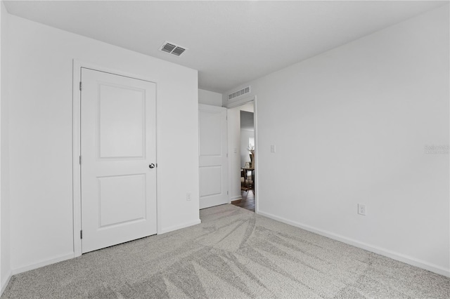 unfurnished bedroom featuring light colored carpet