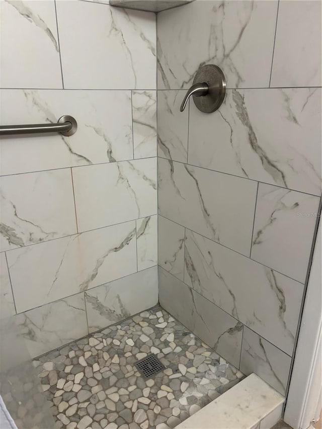 bathroom with tiled shower