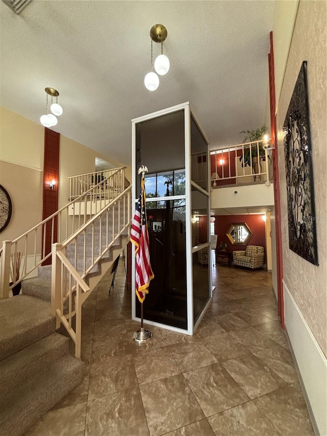 interior space with tile flooring and a textured ceiling