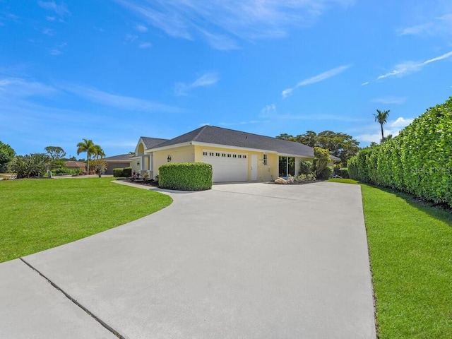 ranch-style home with a front lawn and a garage