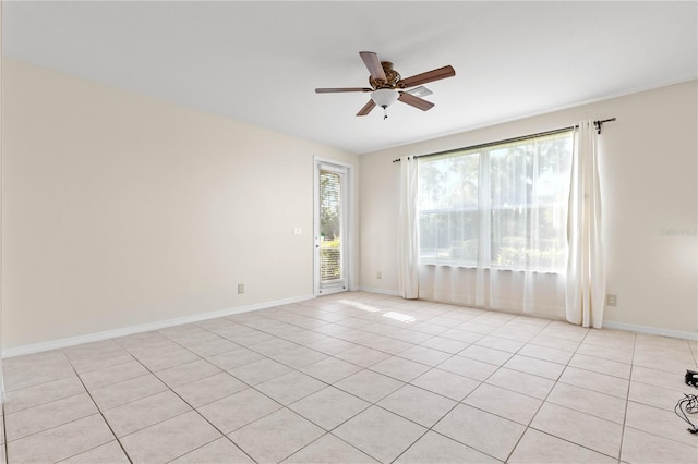 tiled spare room featuring ceiling fan