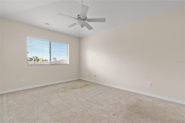 spare room with light carpet and ceiling fan