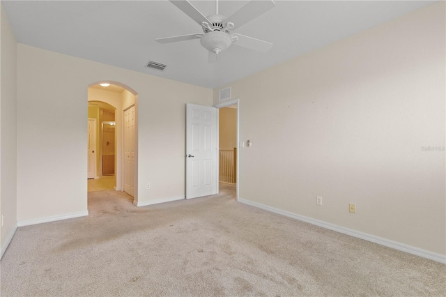 unfurnished room featuring ceiling fan and light colored carpet