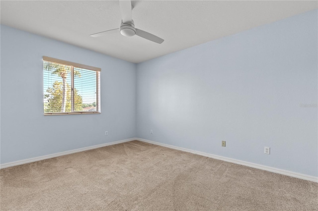 empty room with ceiling fan and light carpet