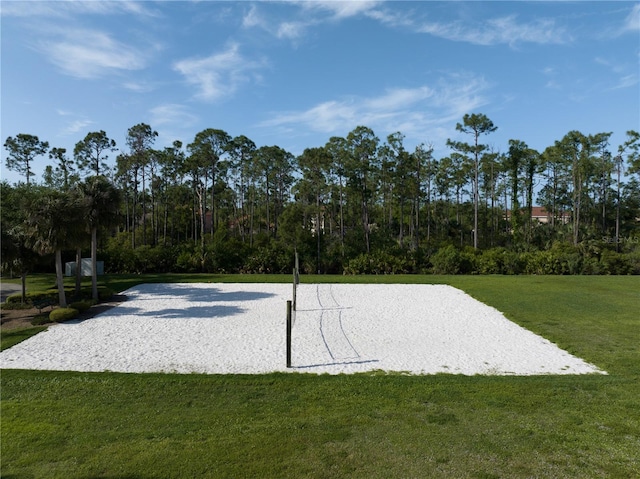 view of property's community featuring a lawn and volleyball court