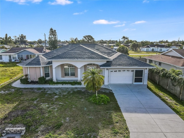 single story home with a front yard and a garage