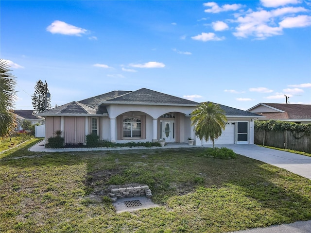 single story home featuring a front yard and a garage