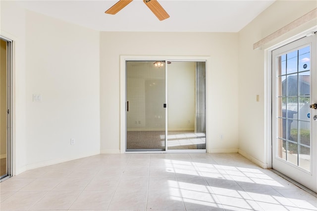 tiled spare room with ceiling fan and a healthy amount of sunlight