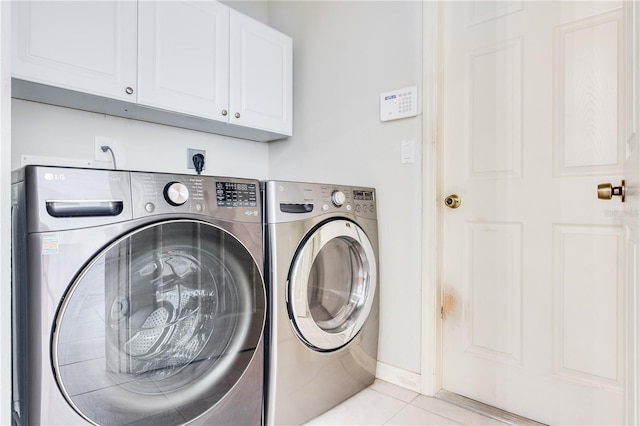 washroom featuring light tile floors, cabinets, hookup for an electric dryer, and independent washer and dryer