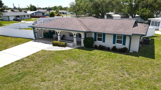 ranch-style home featuring central air condition unit and a front yard