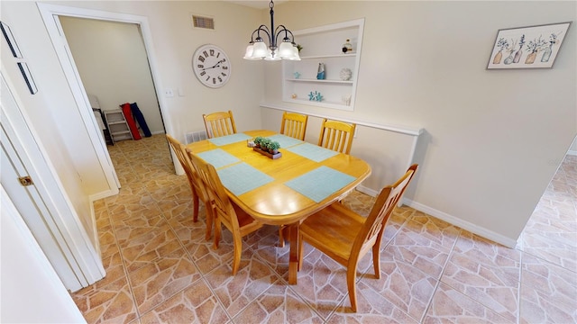 tiled dining room featuring a chandelier