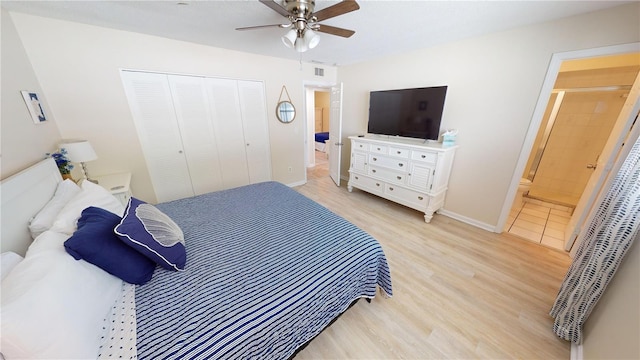 bedroom with ceiling fan, light hardwood / wood-style flooring, ensuite bathroom, and a closet