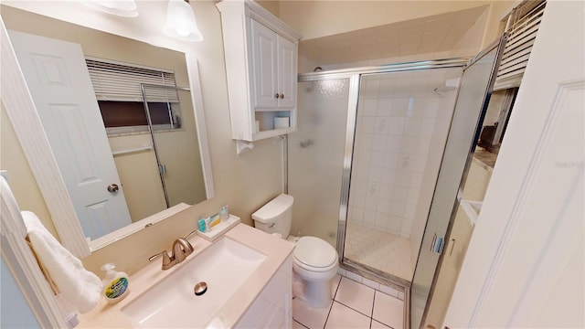 bathroom with a shower with shower door, toilet, tile flooring, and vanity