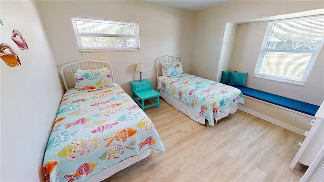 bedroom featuring light hardwood / wood-style floors and multiple windows