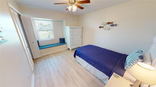 bedroom with a closet, ceiling fan, and light hardwood / wood-style flooring