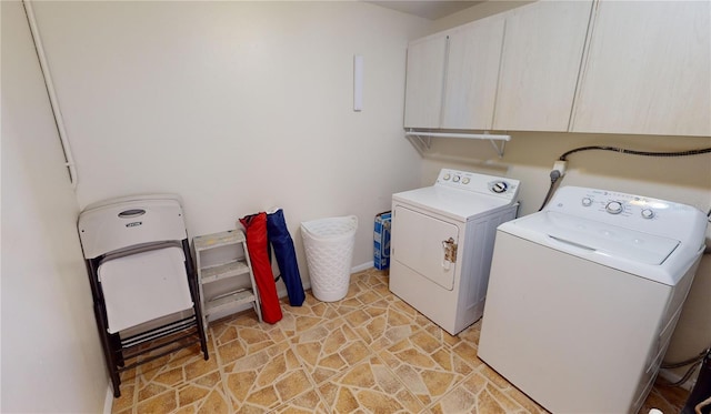 clothes washing area with electric dryer hookup, cabinets, light tile floors, and washing machine and clothes dryer