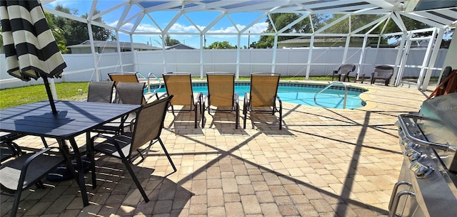 view of swimming pool featuring glass enclosure and a patio