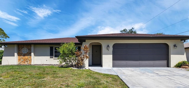 ranch-style home with a garage and a front lawn