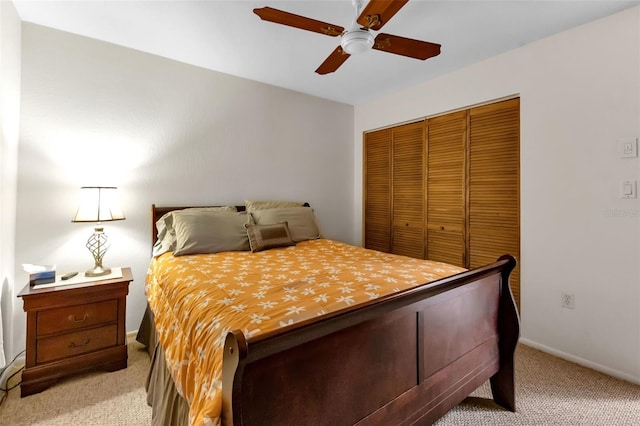 carpeted bedroom featuring ceiling fan and a closet