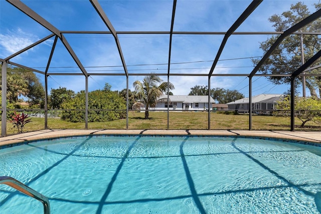 view of pool featuring glass enclosure and a yard