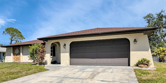 view of front of house with a garage and a front lawn