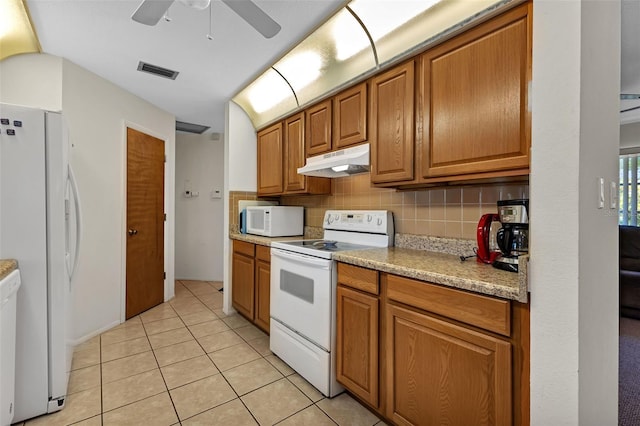 kitchen featuring ceiling fan, white appliances, light tile patterned floors, and tasteful backsplash