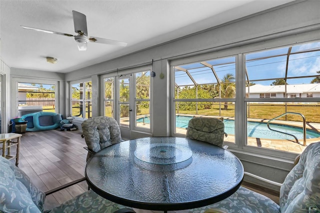 sunroom featuring ceiling fan and plenty of natural light