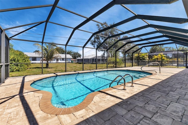 view of pool featuring a lanai, a lawn, and a patio