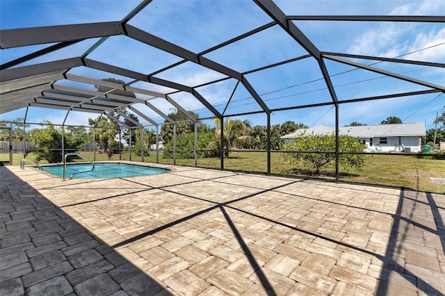 view of swimming pool with glass enclosure, a lawn, and a patio area