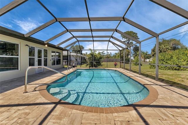 view of pool with a lawn, a lanai, and a patio area