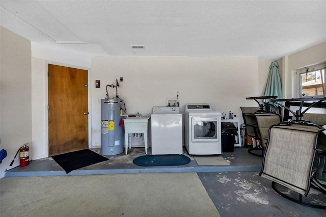 laundry area with washing machine and dryer, sink, a textured ceiling, and electric water heater