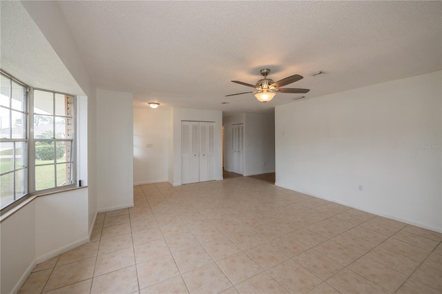 unfurnished room with a textured ceiling and ceiling fan