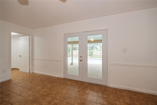 interior space featuring french doors and a textured ceiling