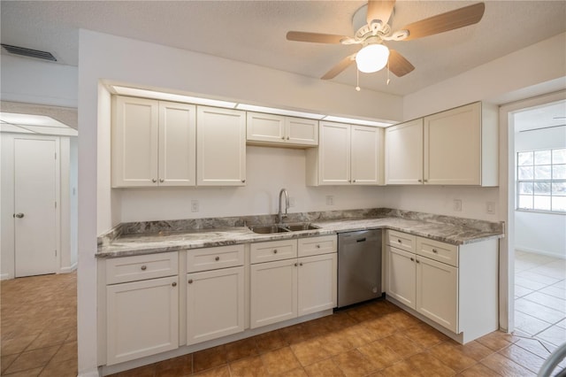 kitchen with dishwasher, sink, ceiling fan, a textured ceiling, and white cabinetry