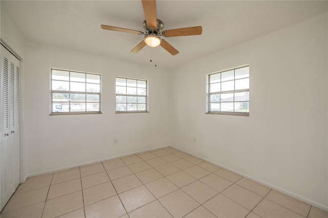 unfurnished room featuring light tile patterned floors and ceiling fan