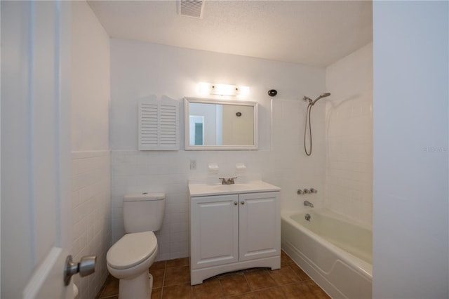 full bathroom with tile patterned flooring, vanity, toilet, and tile walls