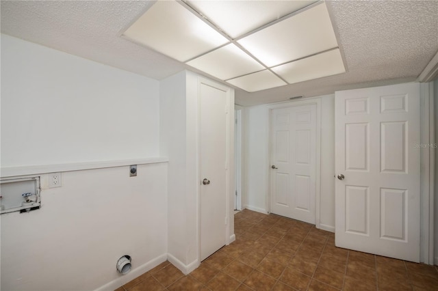 washroom featuring hookup for an electric dryer, a textured ceiling, and washer hookup