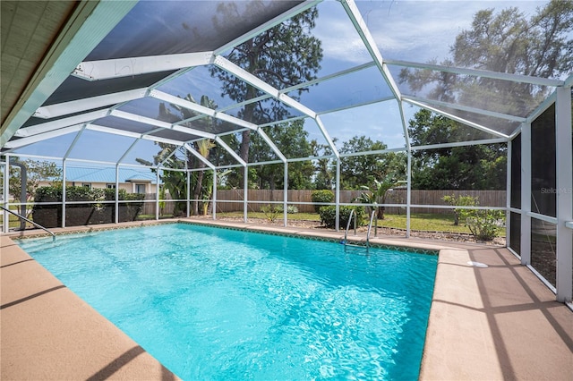 view of pool with a patio area and a lanai