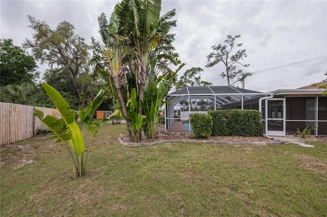 view of yard with a lanai and a swimming pool