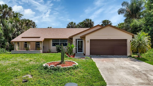 single story home featuring a front lawn and a garage