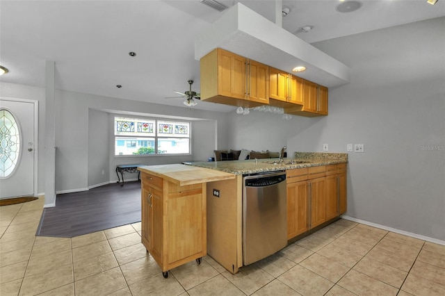 kitchen featuring light tile floors, ceiling fan, kitchen peninsula, and dishwasher