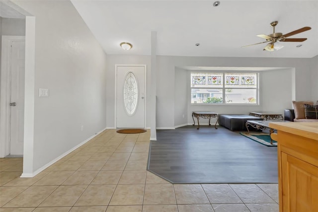 tiled entryway with ceiling fan