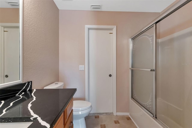 full bathroom with enclosed tub / shower combo, toilet, tile floors, and large vanity