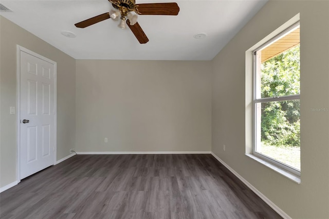 empty room with ceiling fan and dark wood-type flooring