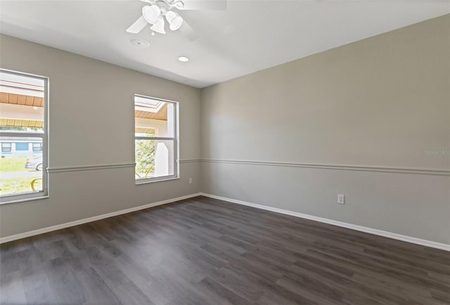 unfurnished room with dark hardwood / wood-style floors and ceiling fan