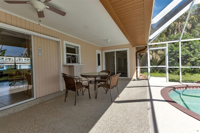 sunroom featuring ceiling fan and vaulted ceiling with skylight