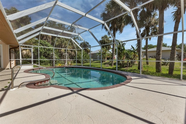 view of swimming pool featuring a lanai and a patio